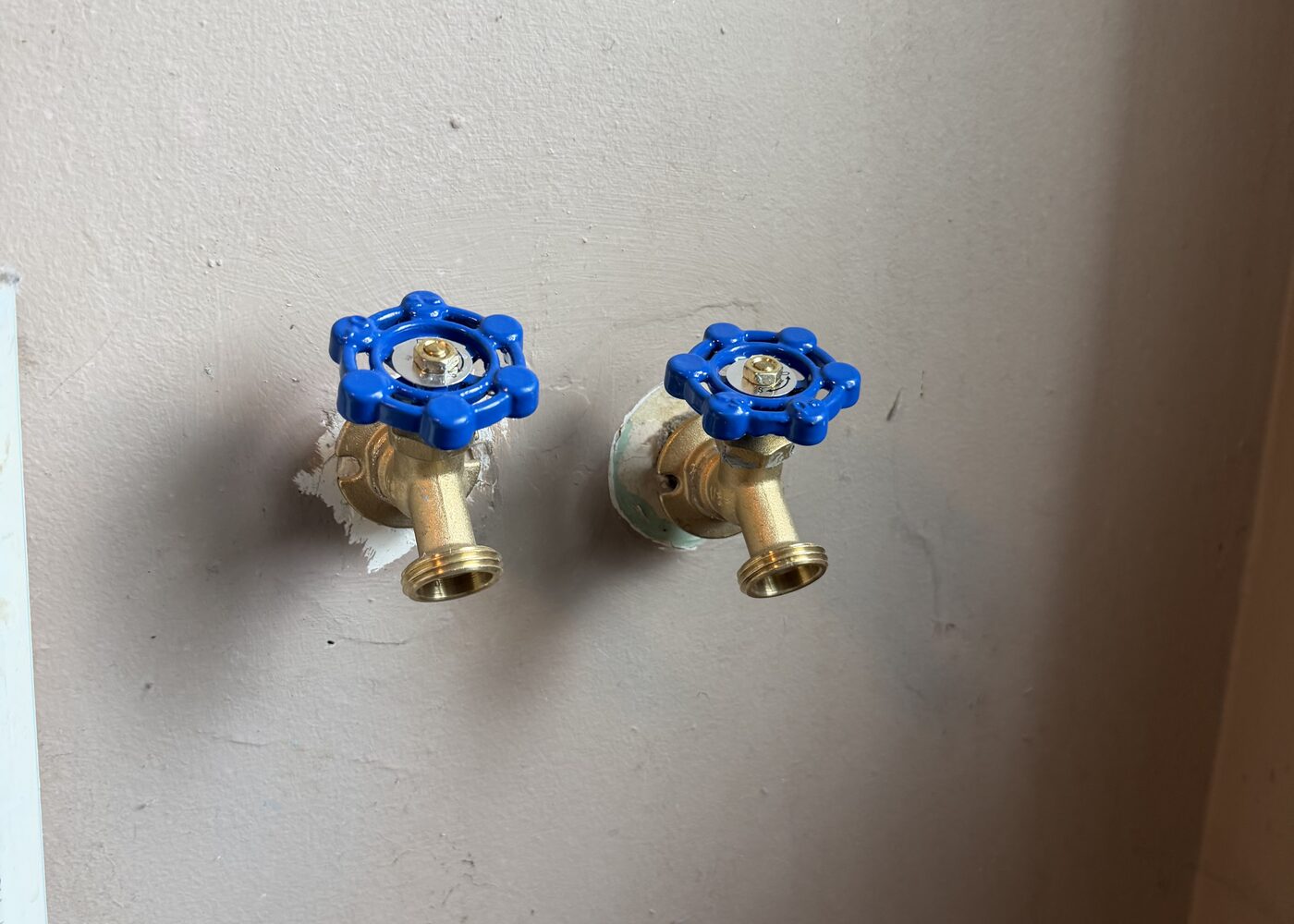 Cleanly installed blue shutoff valves for a plumbing fixture