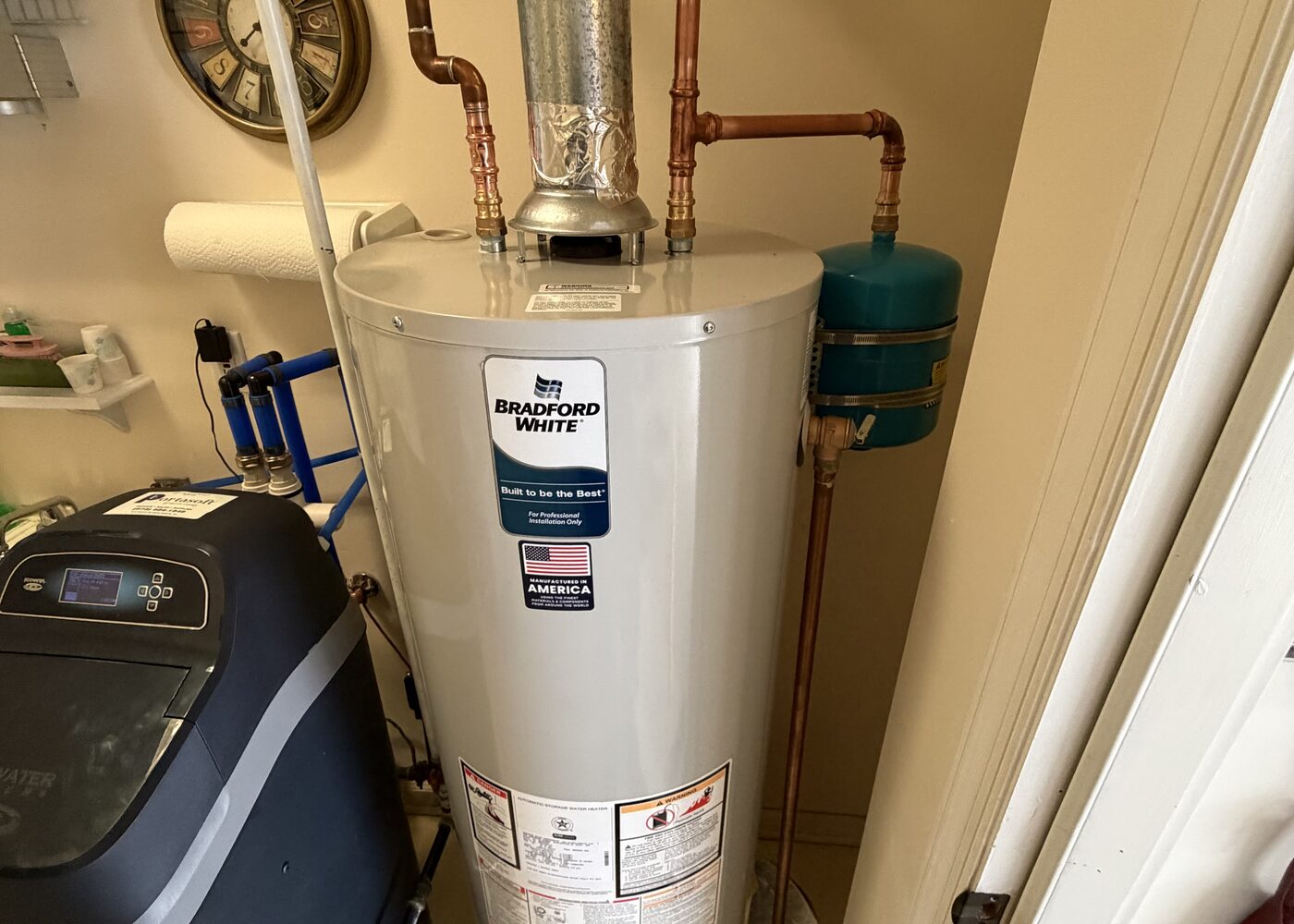 Water heater installation with copper piping and water treatment equipment